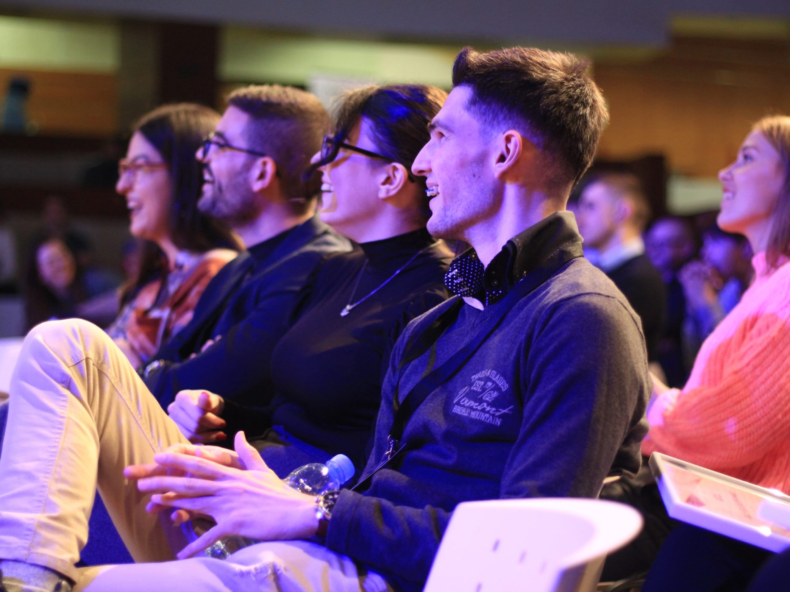 crowd of students laughing at a remark made by the keynote speaker during the speach